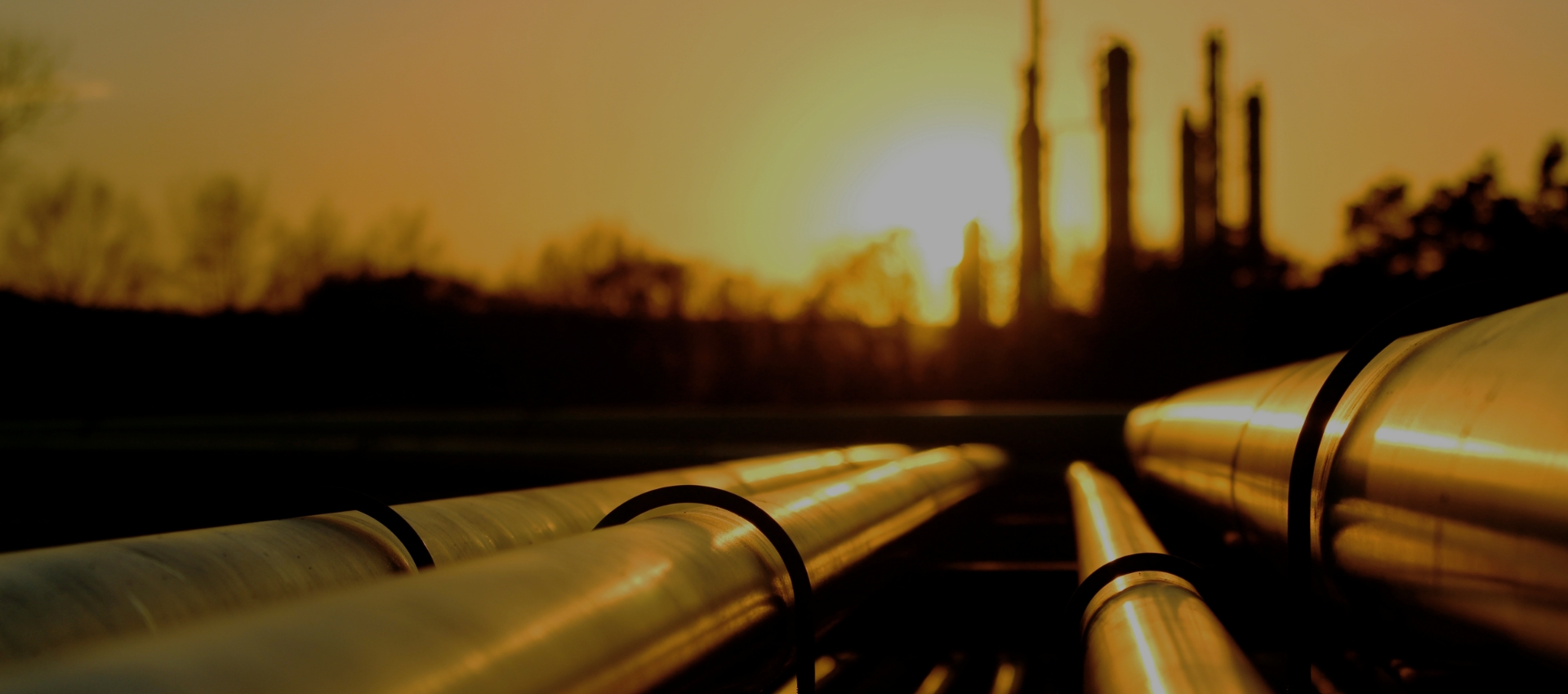 Midstream pipelines approaching an industrial processing facility